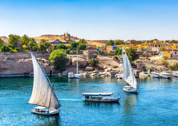 Boats on Nile in Aswan Sunlight over boats on Nile in Aswan, Egypt felucca boat stock pictures, royalty-free photos & images