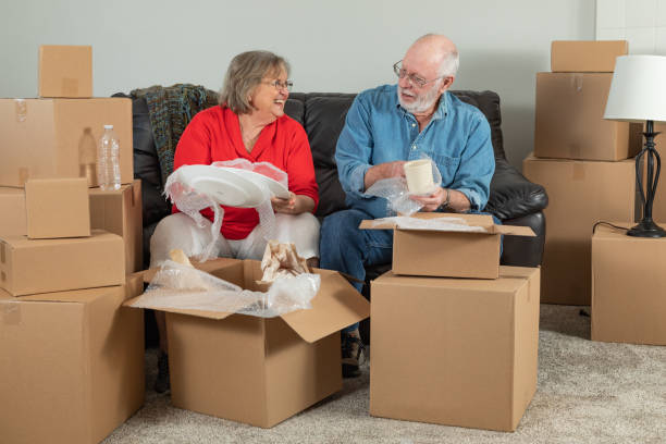 istock Senior Adult Couple Packing or Unpacking Moving Boxes 1173000155