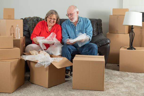 istock Senior Adult Couple Packing or Unpacking Moving Boxes 1173000163