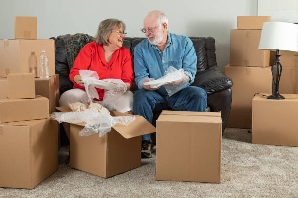 istock Senior Adult Couple Packing or Unpacking Moving Boxes 1173000174