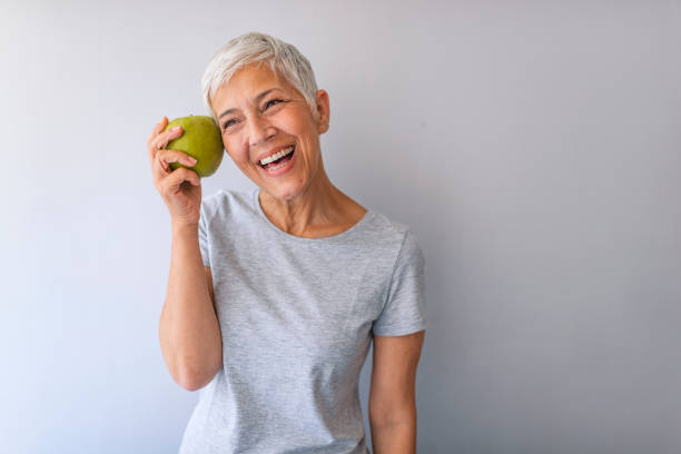 istock Happy Woman Holding Granny Smith Apple 1173001692