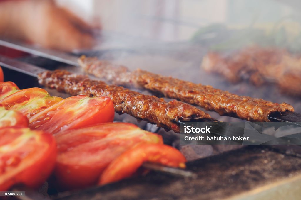 Traditional Turkish Adana Kebab or Kebap on the grill with skewers in the restaurant for dinner Adana, Turkey - Middle East, Kebab, Food, Freshness Kebab Stock Photo