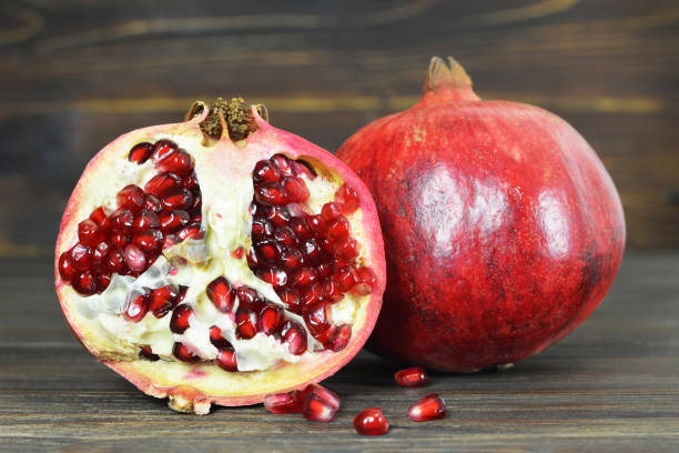 Ripe red pomegranate on wooden background