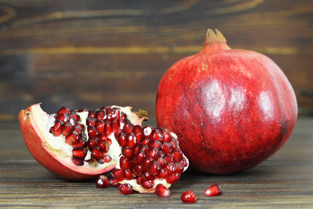 istock Ripe pomegranate on wooden background 1173005447
