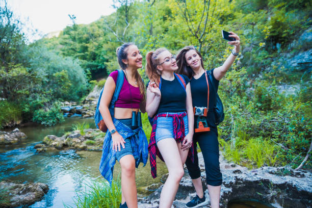 istock Women taking selfie in mountain stream 1173006304