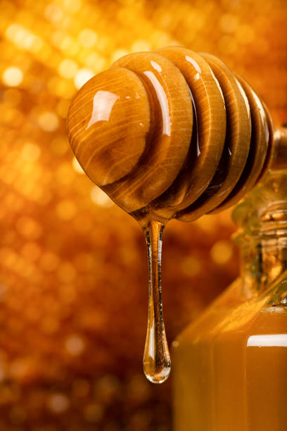 istock acacia honey flows from the ladle in the foreground 1173008969