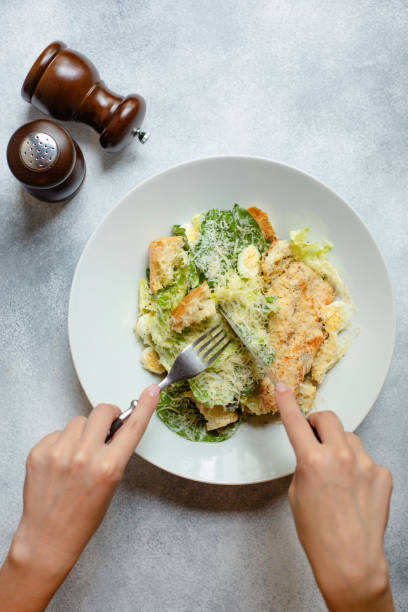 Woman eating classic Caesar salad