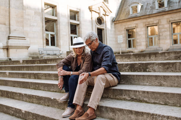 istock Senior couple walking around the city 1173024128