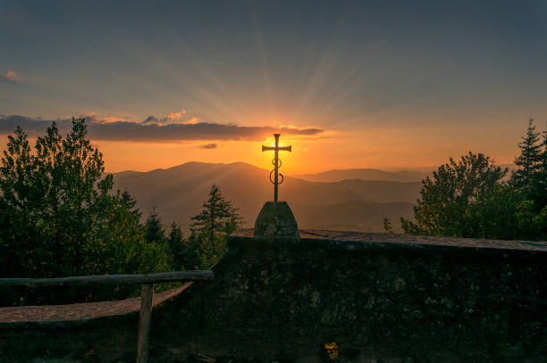 istock Epic landscape with mountains at sunset and catholic cross 1173024691