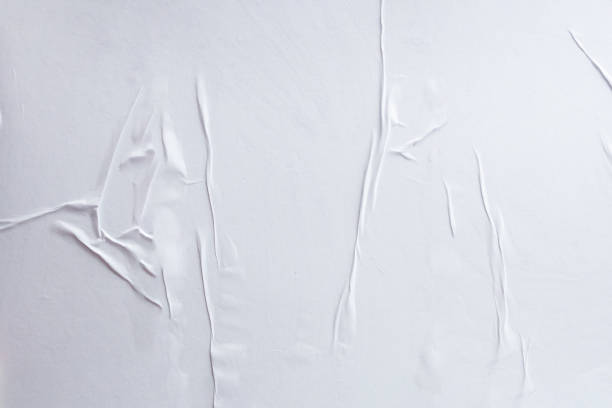 istock Blank white crumpled and creased paper poster texture background 1173024850