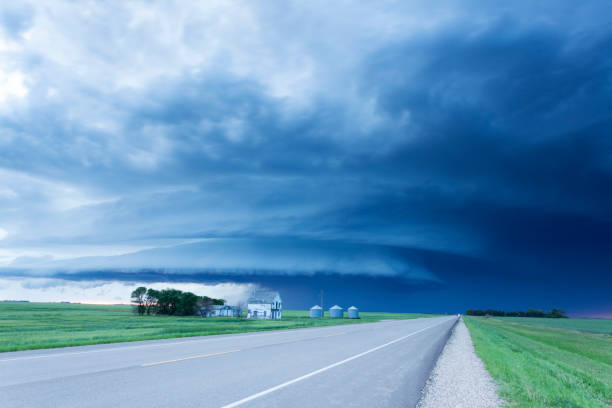 Super Cell Prairie Storm Saskatchewan Canada Tornado alert went off on my phone, I took off and intercepted it, North Of Moose Jaw, Saskatchewan.  20 mins along hwy 2 north. Image taken from a tripod. The wind was extreme and fast moving. country road sky field cloudscape stock pictures, royalty-free photos & images