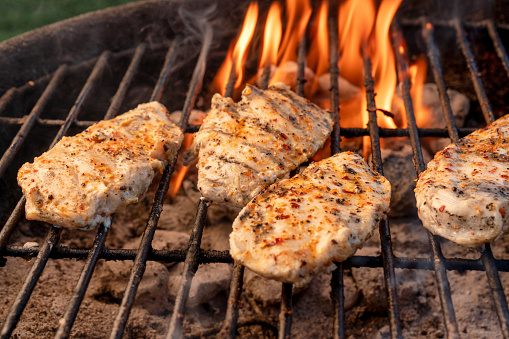 Chicken Breasts Being Grilled on a Fiery Old Fashioned Charcoal Grill, Perfect Ketogenic Diet Food