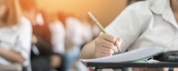 istock Exam at school with student's taking educational admission test in class, thinking hard, writing answer in university classroom, education and world literacy day concept 1173031501