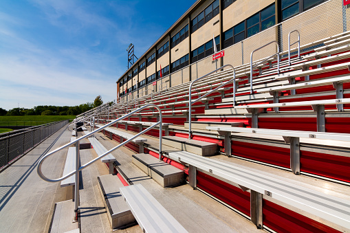 Empty High School stadium bleachers in the Midwest.