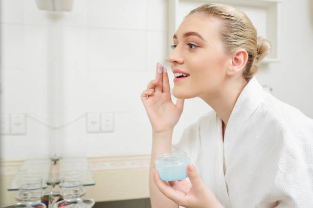 istock Pretty woman applying face cream 1173045471