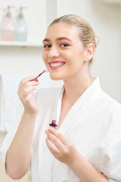 istock Woman applying liquid lipstick 1173045475