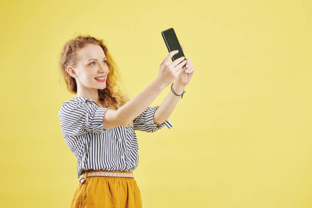 istock Pretty woman posing for video on smartphone 1173045754
