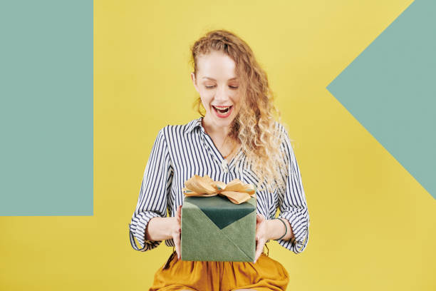 istock Excited woman looking at birthday present 1173045816