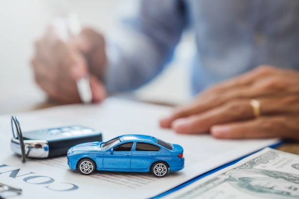 Sale agent  deal to agreement successful car loan contract with customer and sign agreement contract  Insurance car concept. stock photo