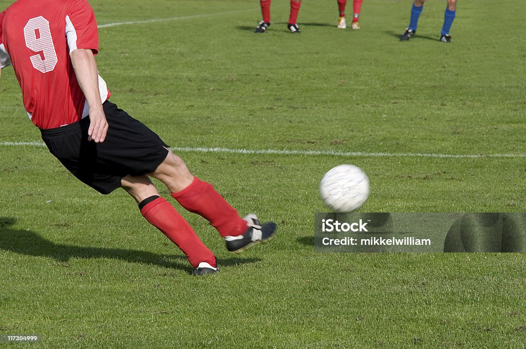 Football player takes a free kick Soccer player kicks ball. Please see some of my other soccer photoshttp://farm4.static.flickr.com/3249/2498292923_0f06bf655b_o.jpg Athlete Stock Photo