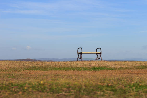 Empty lonely bench standing on the seashore on an autumn day.