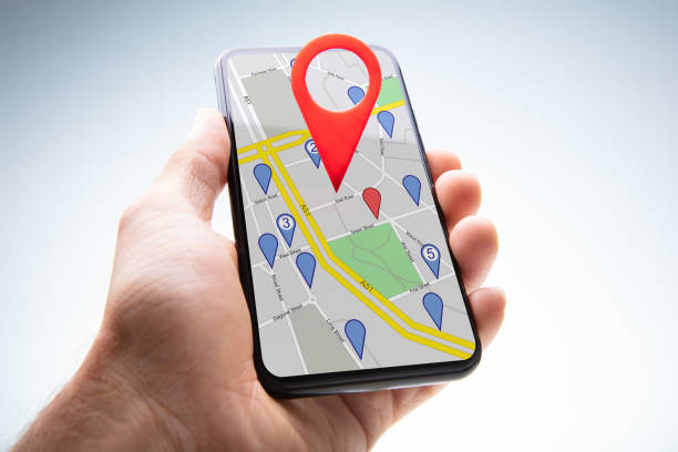 istock Human Hand Holding Cellphone With Navigation Sign 1173054001