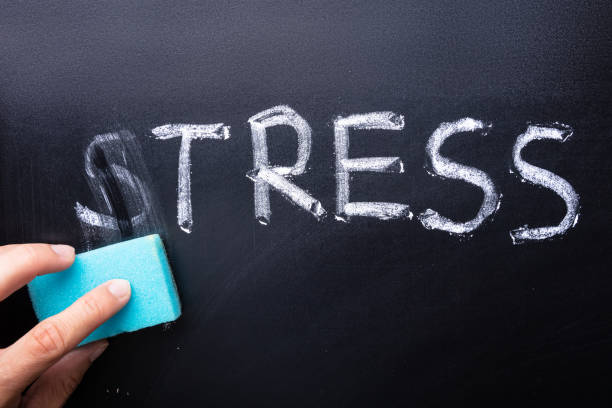 istock Hand Removes From The Slate The Word Stress 1173054023