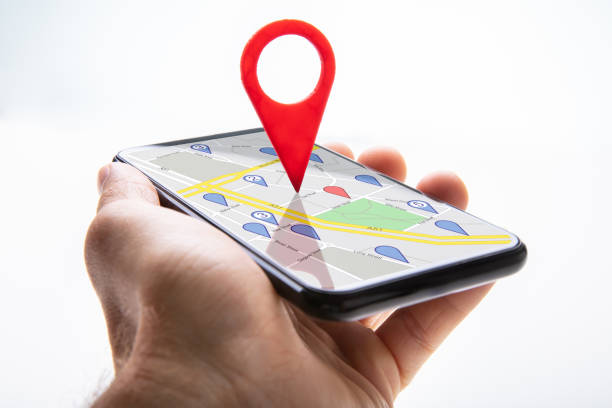 istock Human Hand Holding Cellphone With Navigation Sign 1173054029