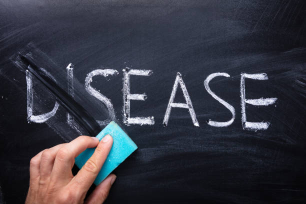 istock Hand Erasing Disease Word Written On Chalkboard 1173054547