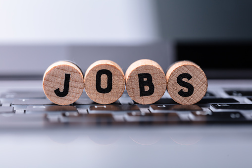 Close-up Of Jobs Text On Wooden Blocks Over Keyboard In Office
