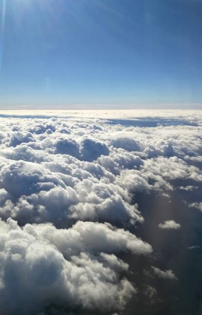 istock Clouds above sea with blue sky overlook view from plane window during flight 1173073227