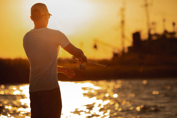 istock Young man fishing at sea 1173078076