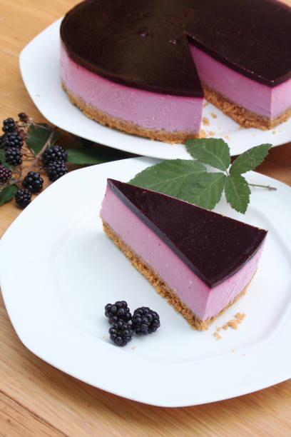 istock Blackberry cheesecake on a white plate on wooden table. 1173080135