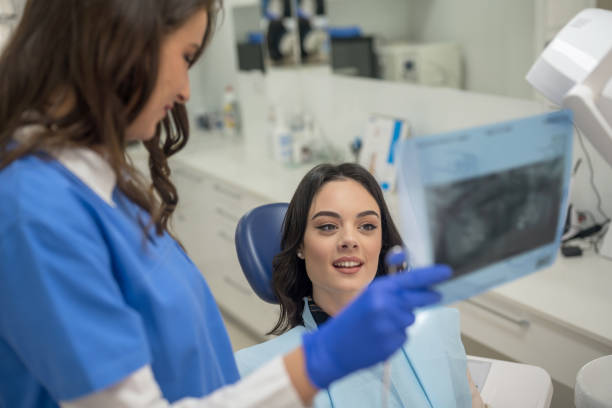 istock Dentist showing x-ray to patient 1173080208