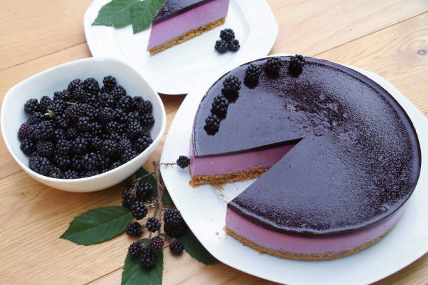 istock Blackberry cheesecake on a white plate on wooden table. 1173080233