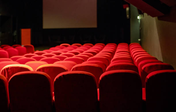 istock Empty movie theatre with red seats 1173080301