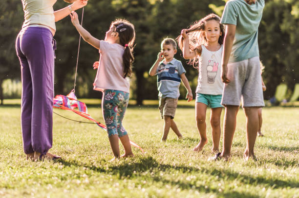 istock Kids playing with kite in nature 1173080938