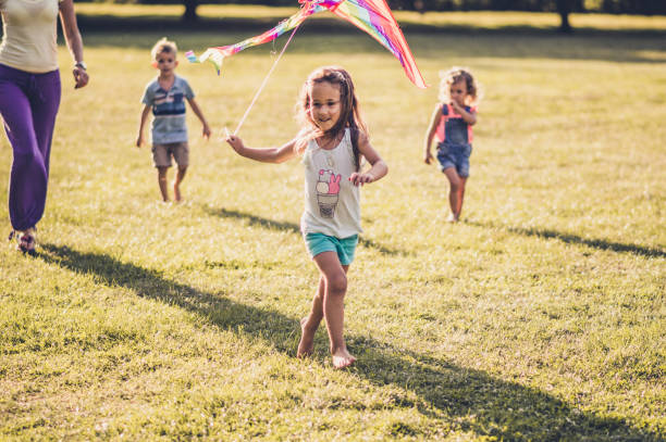 istock Kids running with kite in nature 1173080971