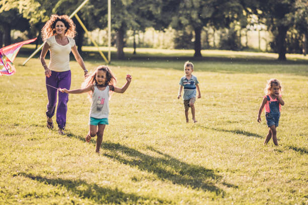 istock Kids running with kite in nature 1173080997