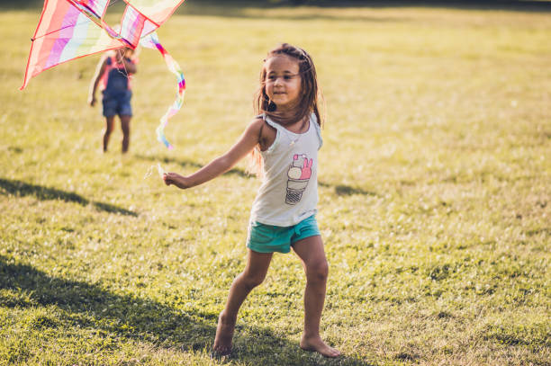 istock Kids running with kite in nature 1173081139