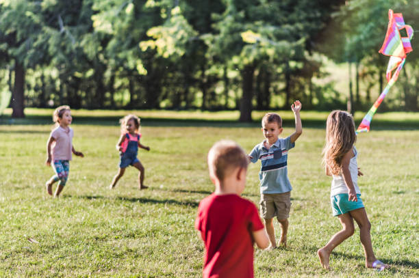 istock Kids running with kite in nature 1173081207