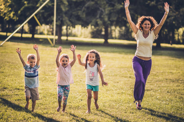 istock Group of happy children having fun while running in nature 1173081247