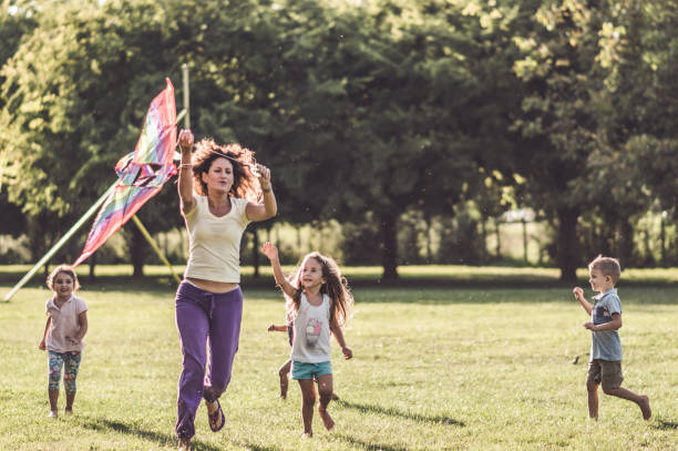 istock Kids running with kite in nature 1173081421