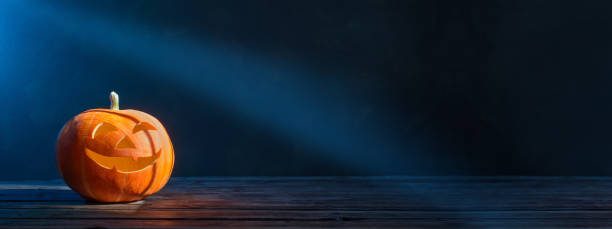 istock Halloween pumpkin on dark background 1173082369