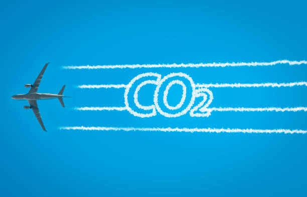 Airplane leaving jet contrails with CO2 word inside Airplane leaving jet contrails with CO2 word inside. Suitable for ecofriendly and sustainable journey concepts and the negative impact on the environment. climate action photos stock pictures, royalty-free photos & images