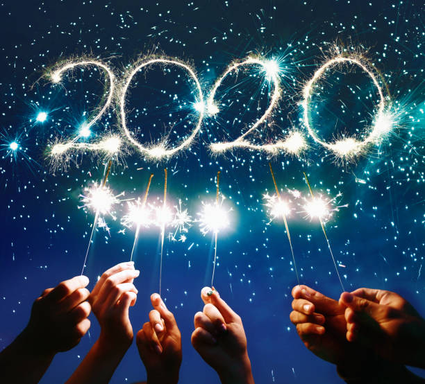 istock hands holding sparklers for new year  2020 at blue night 1173093044