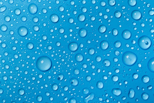 istock Rain droplets on blue glass background, Water drops on blue glass. 1173097447