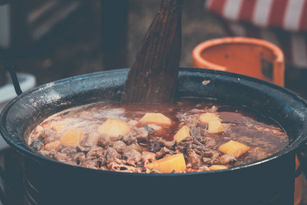 Stew with meat and potatoes cooked in a cauldron