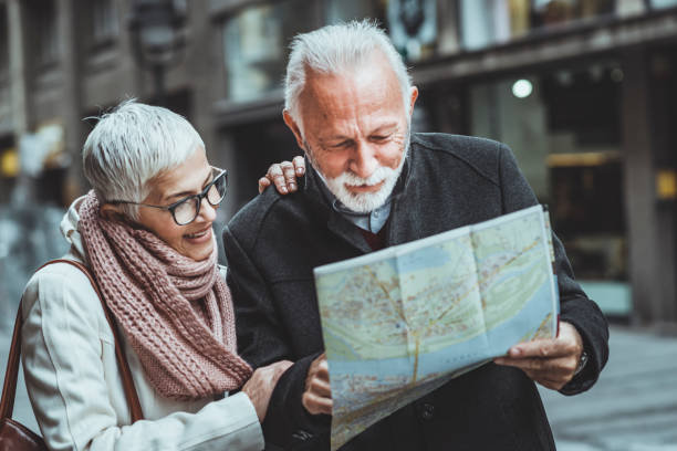 istock Retired Tourist Couple Walking Around The Town With A Map. 1173104518