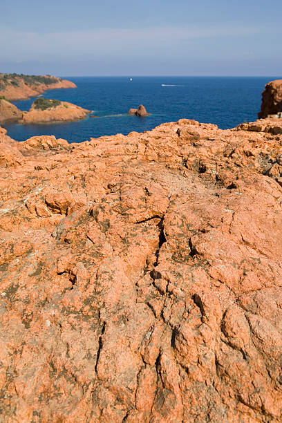 red rocks of the Corniche de l'Esterel red rocks of the Corniche de l'Esterel ending in the Mediterranean Sea; Saint-Raphaël, France corniche de lesterel stock pictures, royalty-free photos & images
